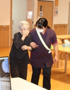 煙を吸い込まないよう鼻や口を覆いながら避難する様子